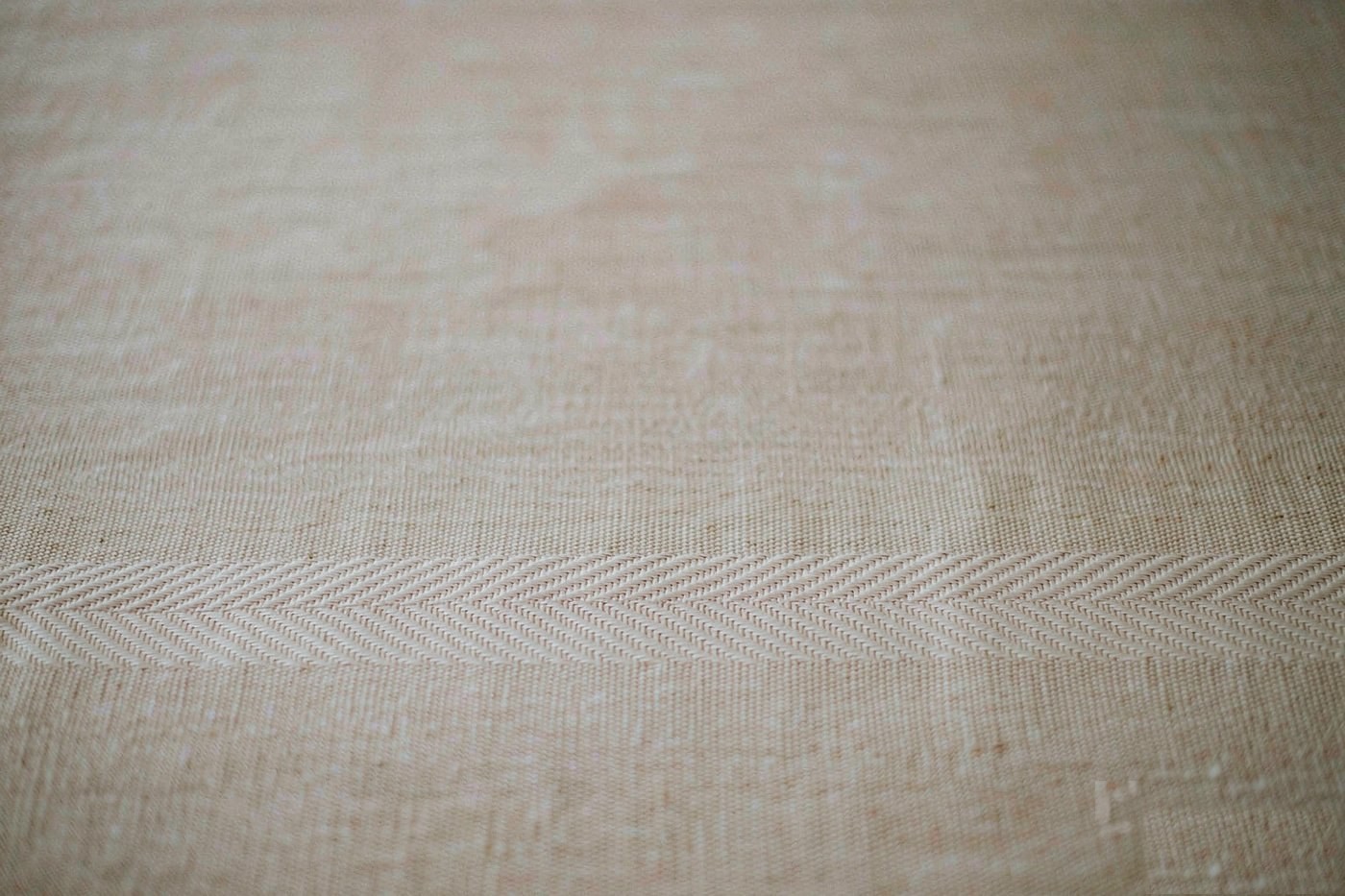 Handwoven textile detail in oatmeal tones